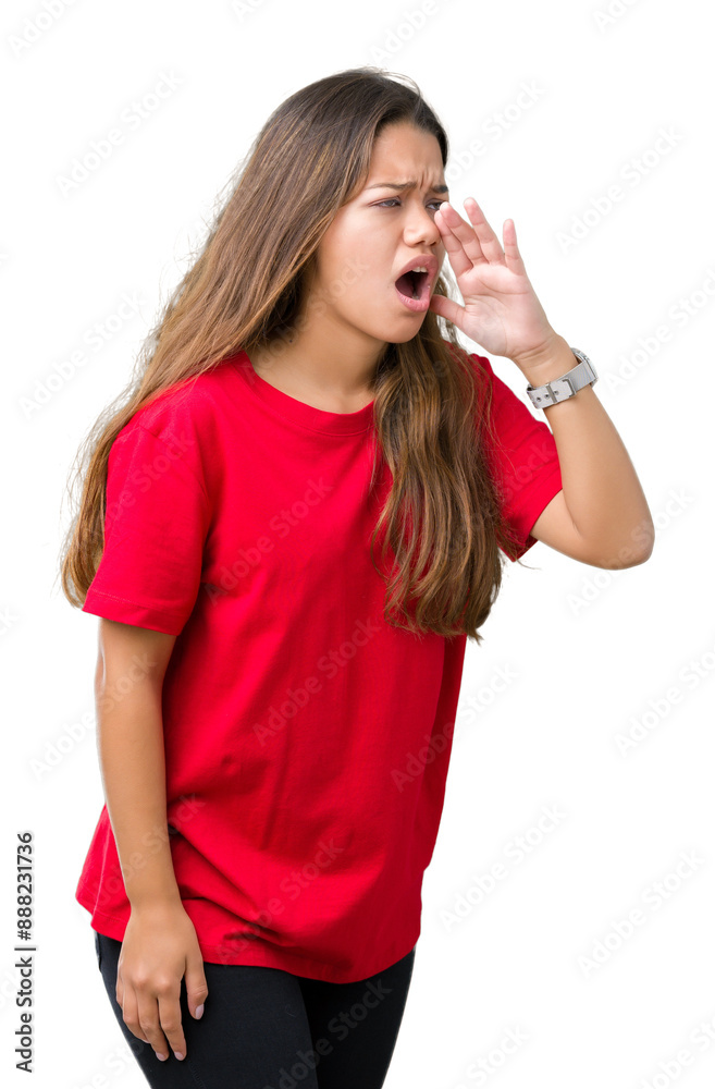 Wall mural Young beautiful brunette woman wearing red t-shirt over isolated background shouting and screaming loud to side with hand on mouth. Communication concept.