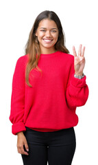 Young beautiful brunette woman wearing red winter sweater over isolated background showing and pointing up with fingers number three while smiling confident and happy.