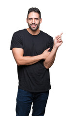 Fototapeta premium Young handsome man over isolated background with a big smile on face, pointing with hand and finger to the side looking at the camera.