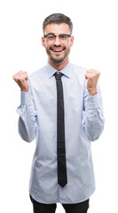 Young business man screaming proud and celebrating victory and success very excited, cheering emotion