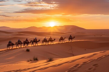 Fototapeta premium Camel caravan at sunrise in Sahara desert Morrocco