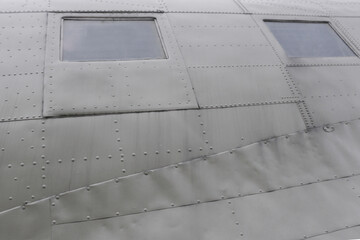 The surface of an old airplane fuselage.