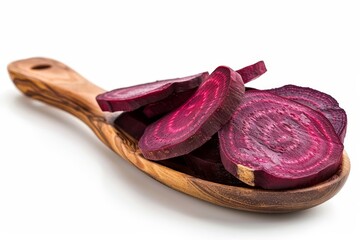 Obraz premium Dehydrated beet slices on wooden spoon with white backdrop