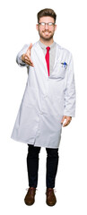 Fototapeta premium Young handsome scientist man wearing glasses smiling friendly offering handshake as greeting and welcoming. Successful business.