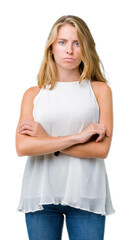 Fototapeta premium Beautiful young elegant woman over isolated background skeptic and nervous, disapproving expression on face with crossed arms. Negative person.