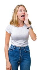 Beautiful young woman wearing casual white t-shirt over isolated background shouting and screaming loud to side with hand on mouth. Communication concept.