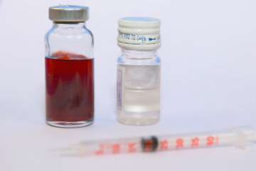 Two Liquid Bottles and Syringe