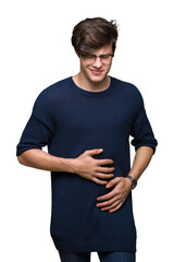 Obraz premium Young handsome man wearing glasses over isolated background with hand on stomach because indigestion, painful illness feeling unwell. Ache concept.