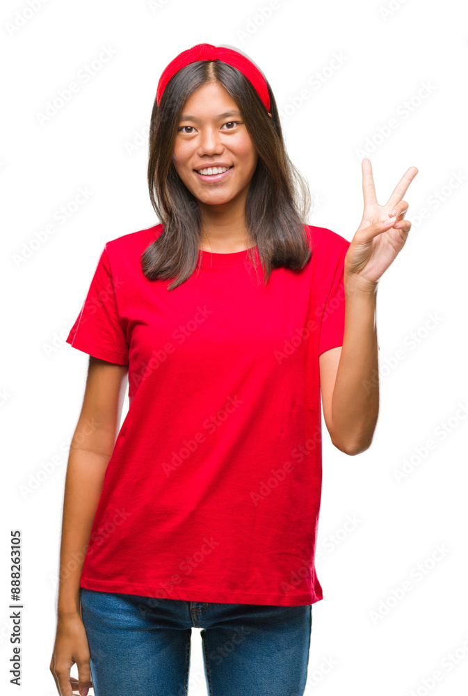 Sticker Young asian woman over isolated background smiling with happy face winking at the camera doing victory sign. Number two.