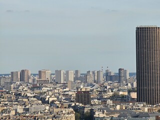 Fototapeta premium Paris, France - April 12, 2024: Aerial view of Paris skyline with dense urban sprawl and modern skyscrapers, Ile de France, France. Amazing mix between modern skyscraoers and old buildings.
