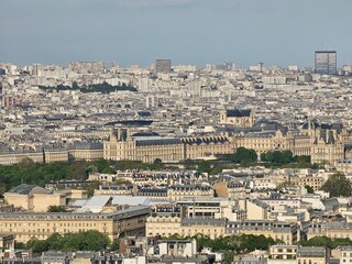 Paris, France - April 12, 2024: Aerial view of Paris skyline with dense urban sprawl and modern skyscrapers, Ile de France, France.  Amazing mix between modern skyscraoers and old buildings.
