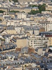 Paris, France - April 12, 2024: Aerial view of Paris skyline with dense urban sprawl and modern skyscrapers, Ile de France, France.  Amazing mix between modern skyscraoers and old buildings.