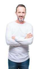 Middle age hoary senior man wearing white t-shirt over isolated background happy face smiling with crossed arms looking at the camera. Positive person.