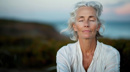 An elderly woman, eyes closed, meditates peacefully by an ocean view, capturing serenity, mindfulness, and the intimate connection between nature and inner peace.