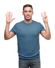 Naklejka premium Handsome young casual man showing and pointing up with fingers number eight while smiling confident and happy.