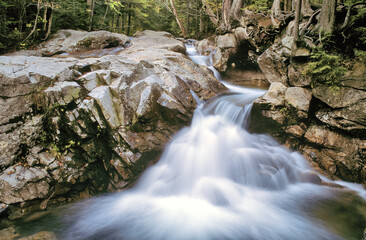 Rocky gorge and scenic waterfall along the Pemigewasset River upstream from The Basin in New Hampshire's Franconia Notch State Park.