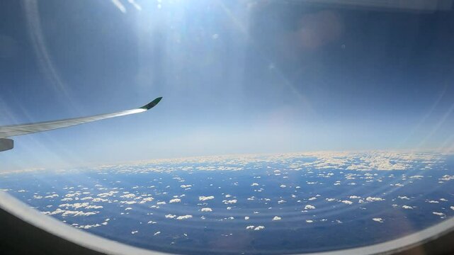 "Passing Through the Clouds: Airplane Window Perspectives" is a stunning stock video that captures the enchanting experience of flying through clouds from the unique vantage point of an airplane.