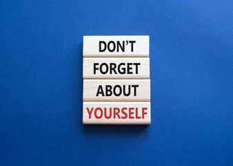 Do not forget about yourself symbol. Concept words Do not forget about yourself on wooden blocks. Beautiful deep blue background. Business concept. Copy space