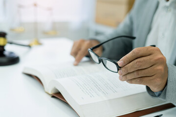 university student prepares for exams in a library, engrossed in legal studies with books and glasses, dedicated to gaining knowledge and academic success.
