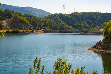 Obraz premium Radoinja Lake (Radoinjsko jezero)- a water gem in the Uvac Canyon, on the Zlatar mountain, surrounded by pine woods, a dam in the background, Serbia
