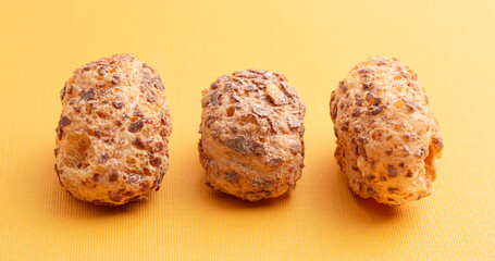 Freeze Dried Milk Chocolate Covered Caramel Disks on Yellow Background