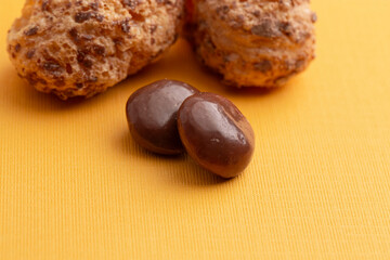 Freeze Dried Milk Chocolate Covered Caramel Disks on Yellow Background