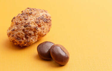 Freeze Dried Milk Chocolate Covered Caramel Disks on Yellow Background