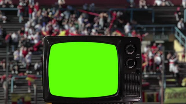 Antique Television with Green Screen and Blurred Stadium Fans in the Background. You can replace green screen with the footage or picture you want with &ldquo;Keying&rdquo; effect in After Effects. 