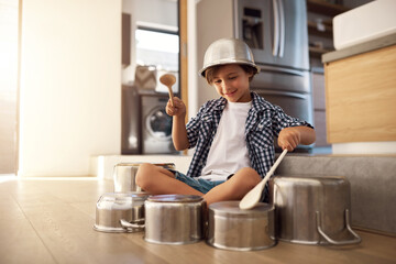 Child, floor and pots for drums in home for playing, entertainment and childhood imagination for...