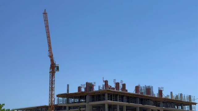 A construction crane performs construction work 