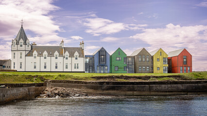 The harbor at John O' Groats and the colored houses at one of the northernmost points of Scotland if you arrive via the North Coast 500 route.