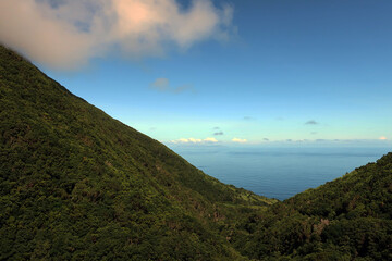 Obraz premium View of the hiking trail starting in Serra do Topo - Caldeira Santo Cristo - Fajã dos Cubres in São Jorge island, Azores, Portugal.