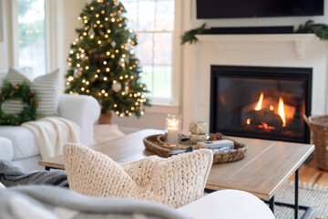 A cozy living room with a Christmas tree and a fireplace