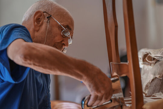 upholsterer craftsman working in the workshop