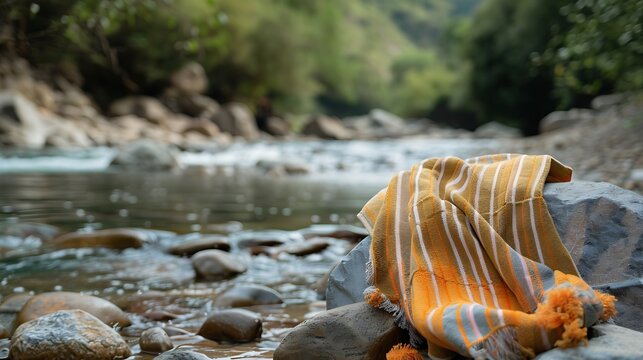 A beautuful stylish towel on the stone where the river curved