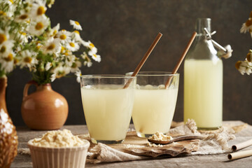 Fresh natural whey in two glass cups with recyclable paper straws