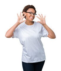 Fototapeta premium Beautiful young african american woman wearing glasses over isolated background showing and pointing up with fingers number ten while smiling confident and happy.