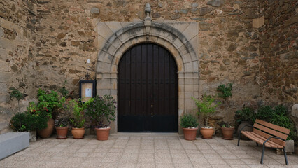 Old building facade. Peculiar housing. Rural construction. Original door of old building. Typical Mediterranean urban planning.