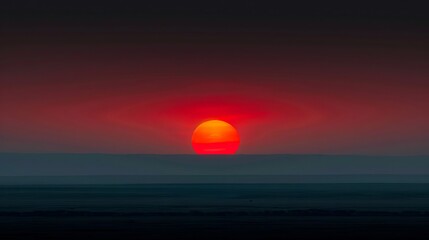 A red sun is setting over a large area.
