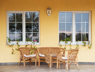 Cafe terrace with wicker furniture on a summer day.