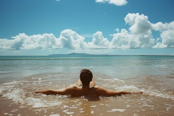 a woman sitting on the beach looking out at the ocean, Contentedly sunbathing on beach