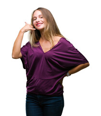 Fototapeta premium Young beautiful blonde elegant woman over isolated background smiling doing phone gesture with hand and fingers like talking on the telephone. Communicating concepts.