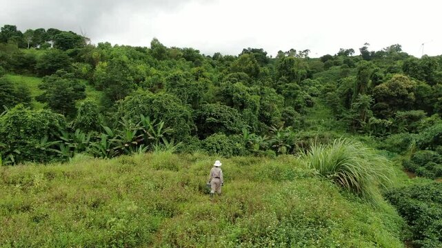 A female mine sapper walks across a green field