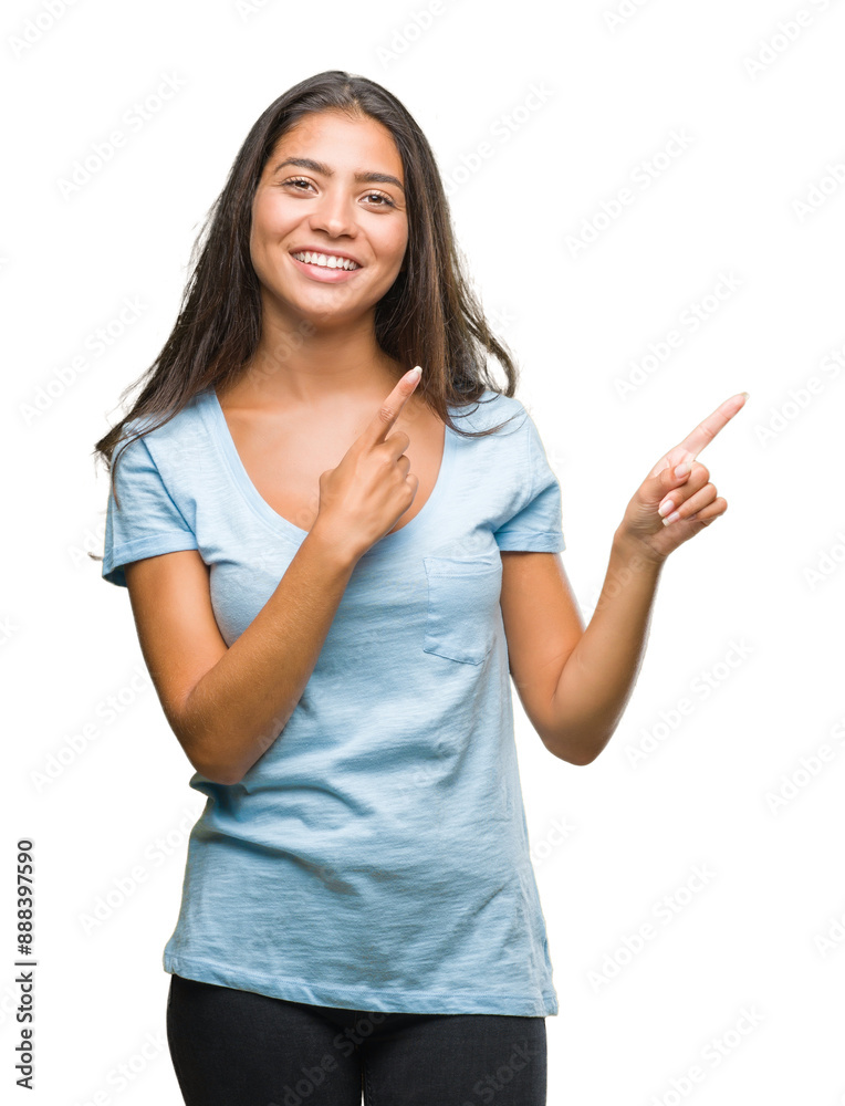 Canvas Prints Young beautiful arab woman over isolated background smiling and looking at the camera pointing with two hands and fingers to the side.