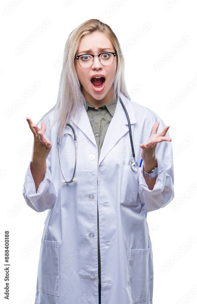 Canvas Prints Young blonde doctor woman over isolated background crazy and mad shouting and yelling with aggressive expression and arms raised. Frustration concept.