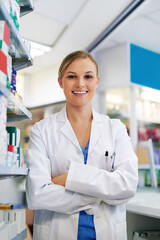 Woman, confident and pharmacist portrait in pharmacy, trust and drug store or medication dispensary. Healthcare, worker and medicine retailer for career, crossed arms and professional for wellness