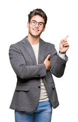 Young business man wearing glasses over isolated background Pointing with hand finger to the side showing advertisement, serious and calm face