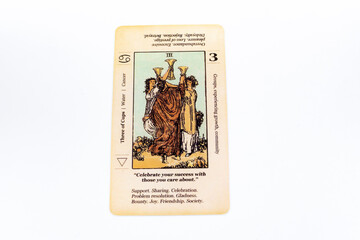 Fototapeta premium Tarot cards, Waite Rider tarot cards, the three of cups card in the foreground on a background of available deck cards