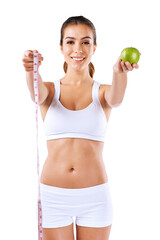 Girl, fruit and measuring tape in portrait for fitness, weight loss and diet in white background. Female person, metabolism and wellness for nutrition, apple or choice with healthy food in studio