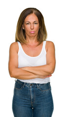 Obraz premium Beautiful middle age casual adult woman over isolated background skeptic and nervous, disapproving expression on face with crossed arms. Negative person.